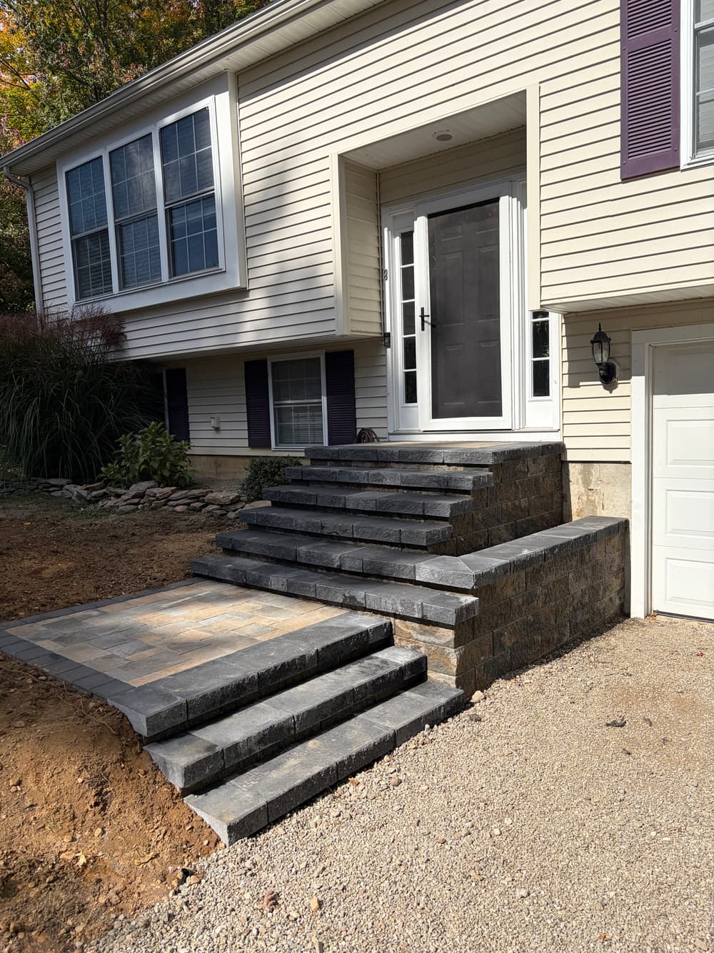 Newly constructed stone steps leading to a front door with a landscaped entrance.